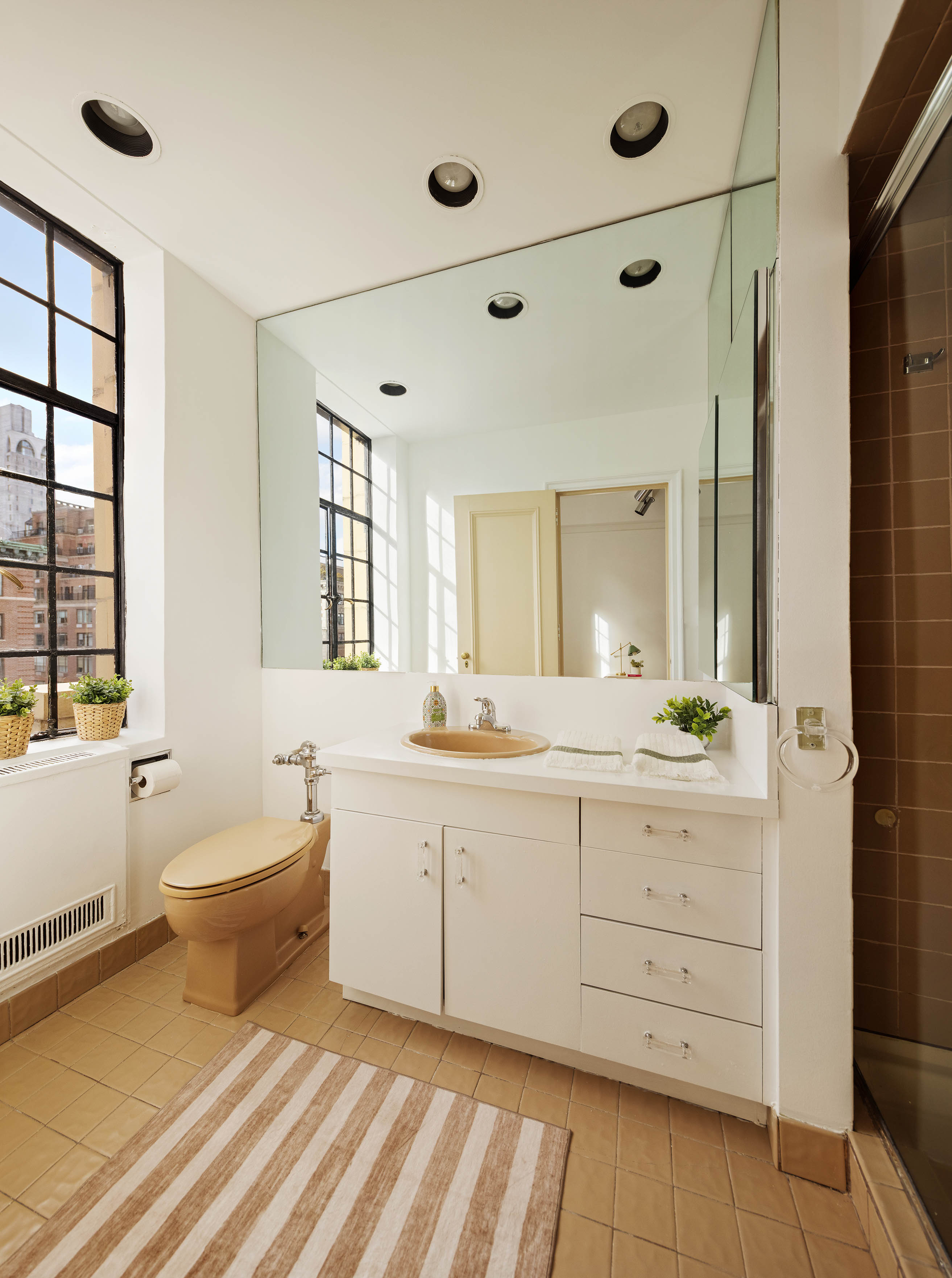 1100 Park Avenue, Unit 14B Manhattan, NY 10128 - Photo 8 of 14 a spacious bathroom with a double vanity sink a mirror and a bathtub