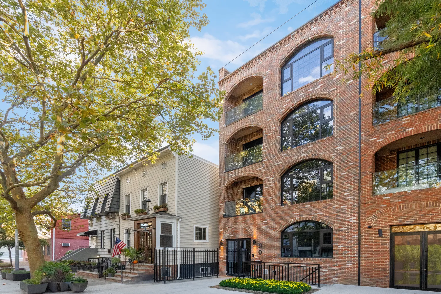 a front view of residential building with yard and outdoor seating