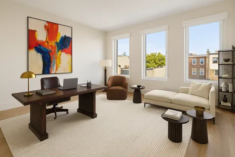 a living room with furniture rug and window
