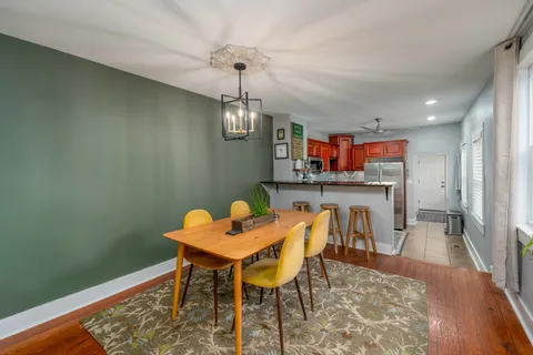 a view of a dining room with furniture and wooden floor