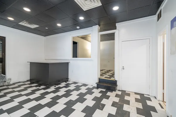 a view of a room with a black and white checkered floor