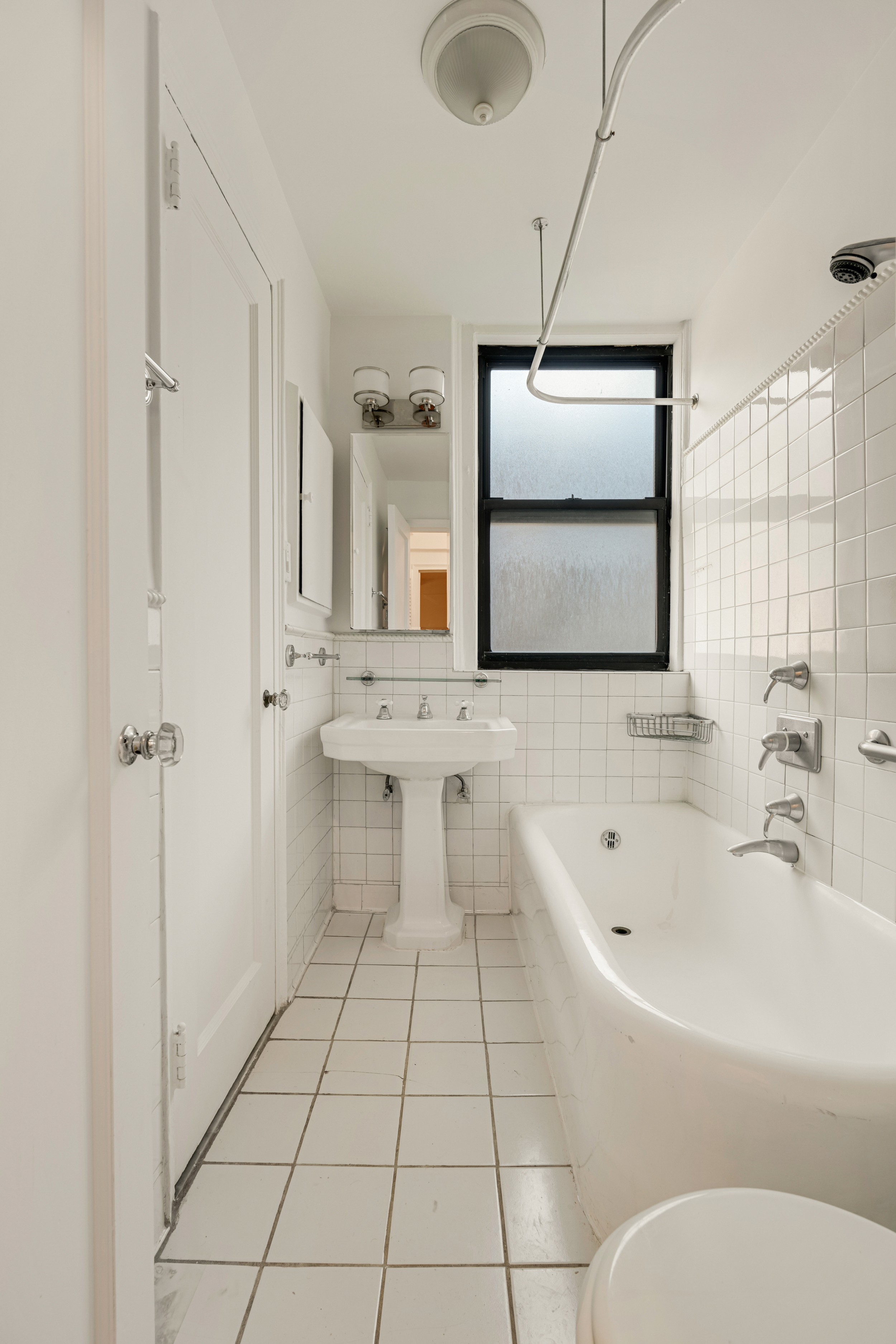 74 West 68th Street, Unit 5A Manhattan, NY 10023 - Photo 10 of 25 a bathroom with a bathtub sink and mirror