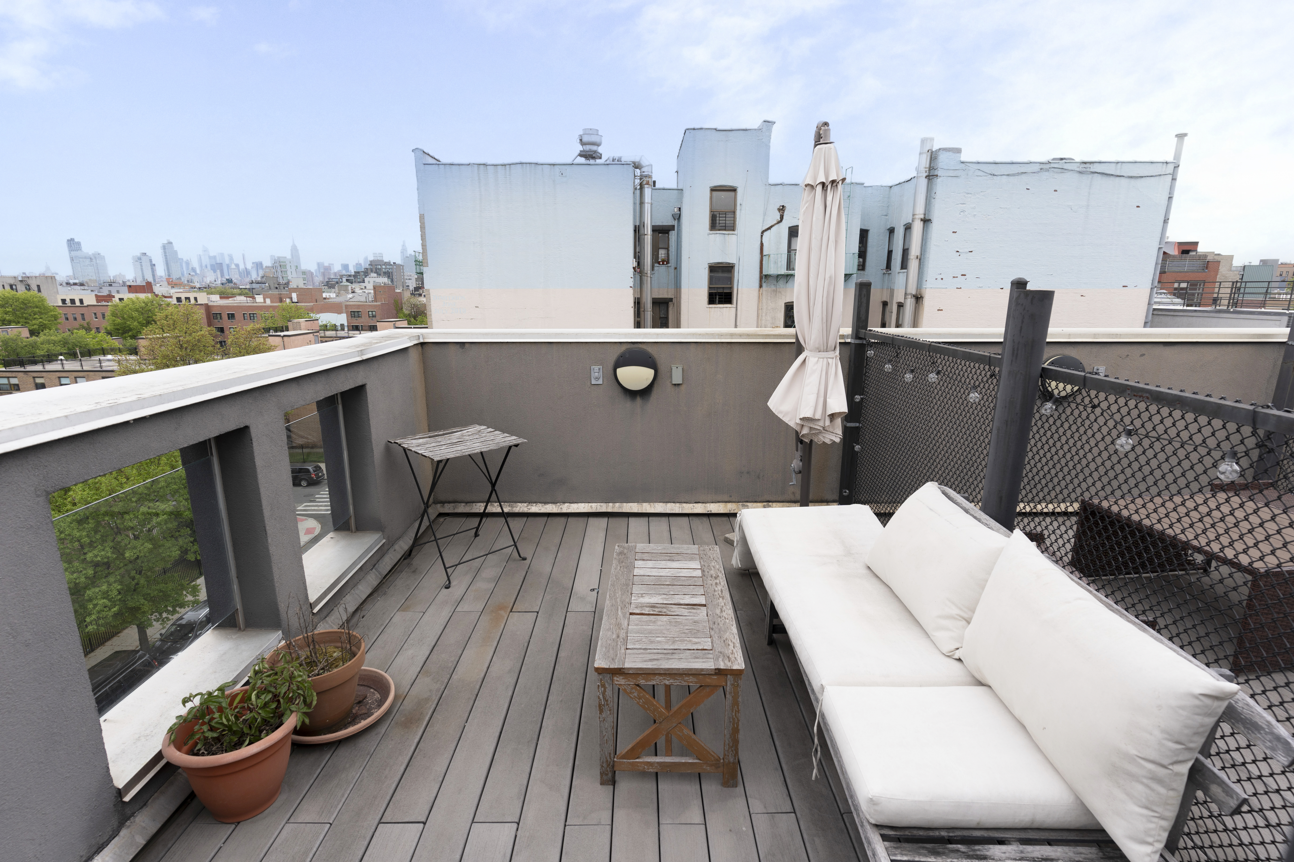 390 Lorimer Street, Unit 3H Brooklyn, NY 11206 - Photo 7 of 13 a view of a balcony with chairs and wooden floor