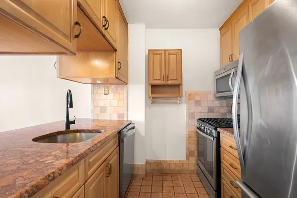 a kitchen with a sink stove and refrigerator