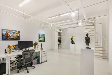 a view of a workspace with furniture