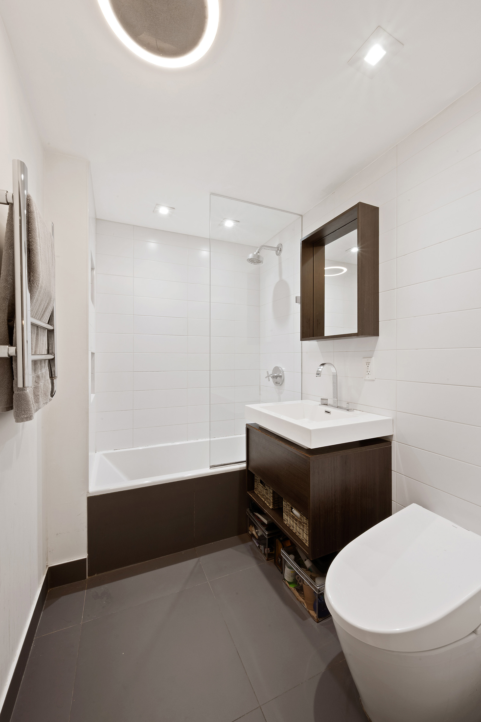 138 North 3rd Street, Unit 1 Brooklyn, NY 11249 - Photo 6 of 9 a bathroom with a sink a toilet and mirror