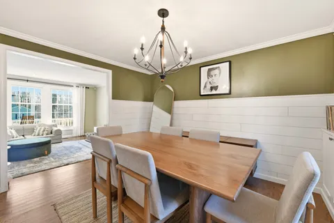 a view of a dining room with furniture wooden floor and chandelier