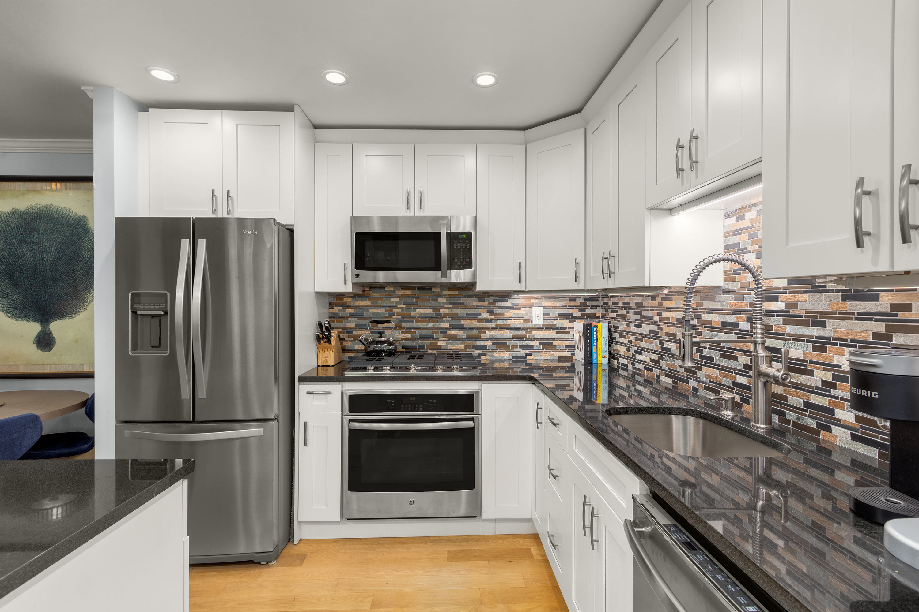 7 East 35th Street, Unit 2E Manhattan, NY 10016 - Photo 3 of 10 a kitchen with stainless steel appliances granite countertop a sink stove and refrigerator