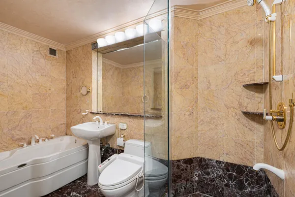 a bathroom with a toilet a sink and shower