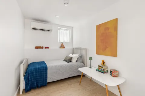 a bedroom with a bed and a table in it