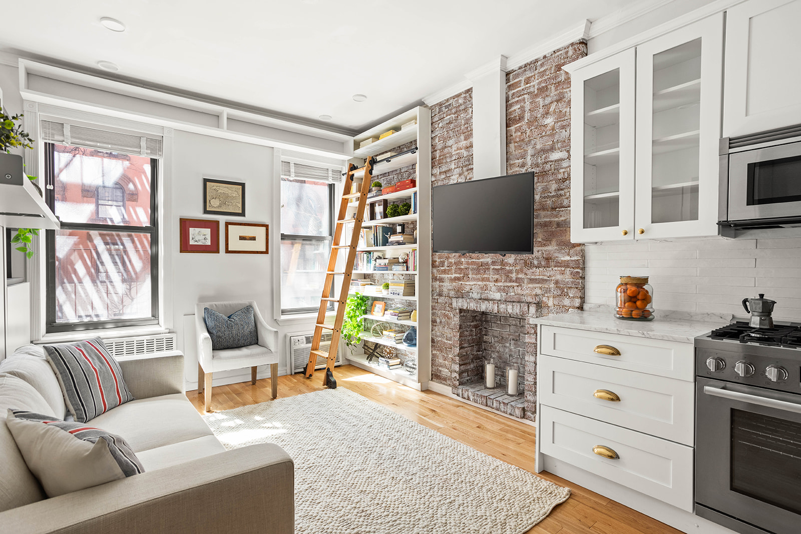 227 East 87th Street, Unit 1B Manhattan, NY 10128 - Photo 1 of 6 a living room with furniture fireplace and flat screen tv