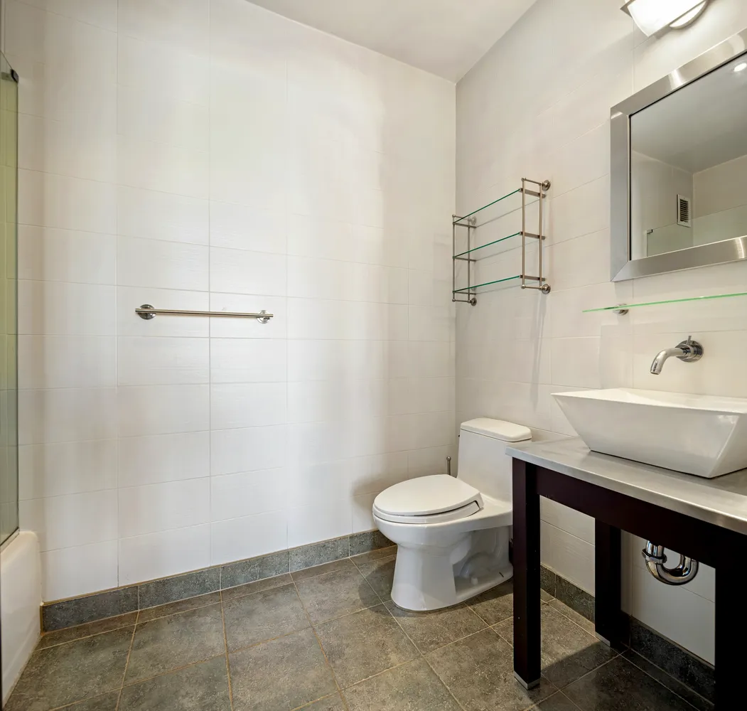 a bathroom with a sink a toilet and mirror