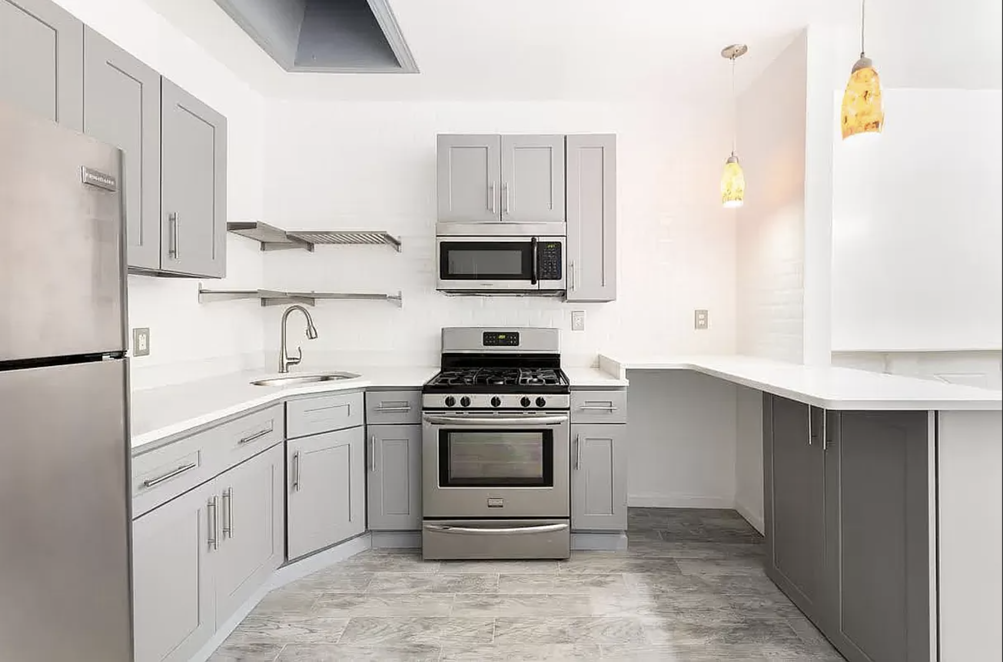 582 Monroe Street, Unit 2 Brooklyn, NY 11221 - Photo 5 of 18 a kitchen with stainless steel appliances granite countertop a stove a sink and a refrigerator