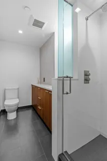 a bedroom with a bed a table and painting on the wall