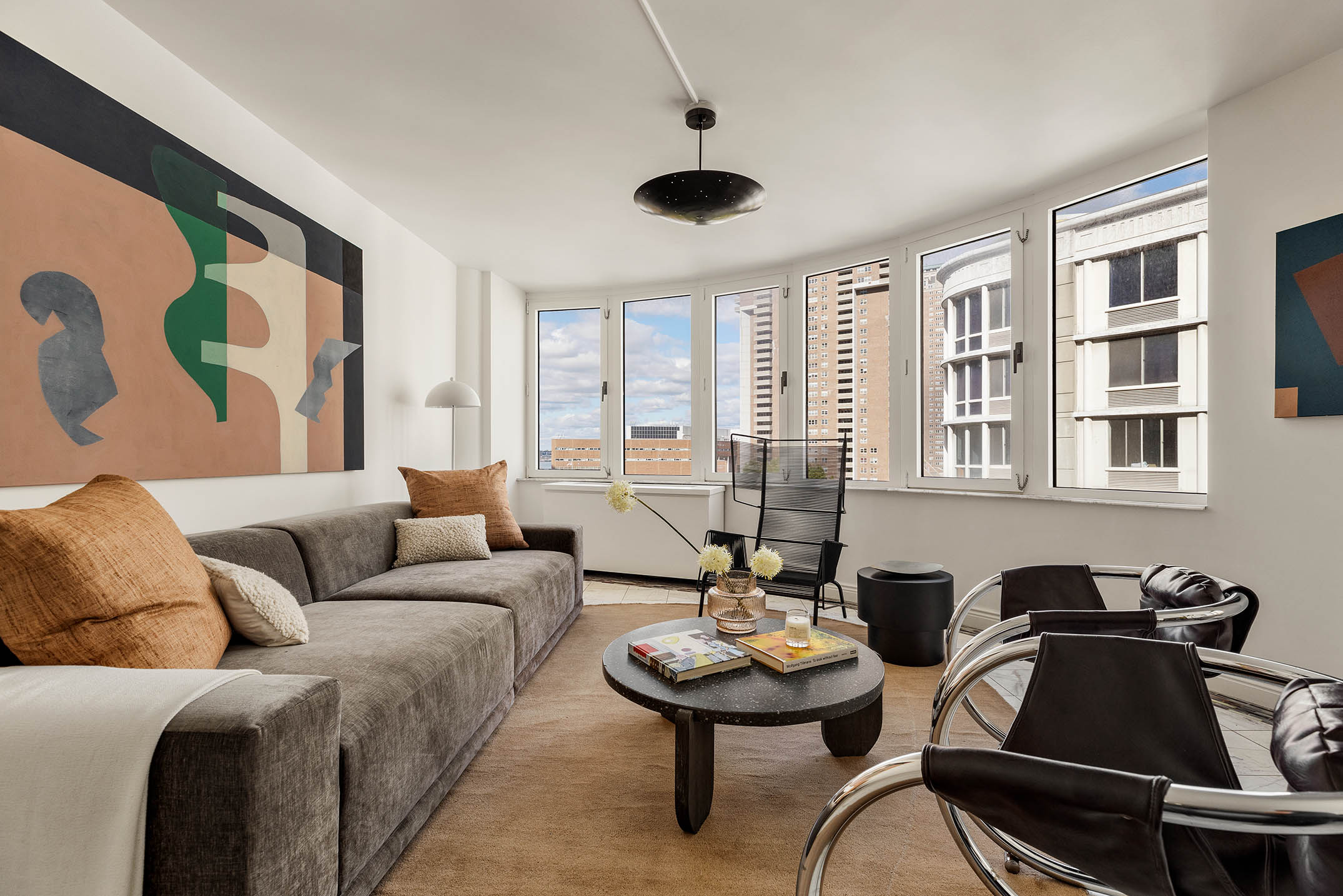 295 Greenwich Street, Unit 8/9H Manhattan, NY 10007 - Photo 2 of 22 a living room with furniture and a large window
