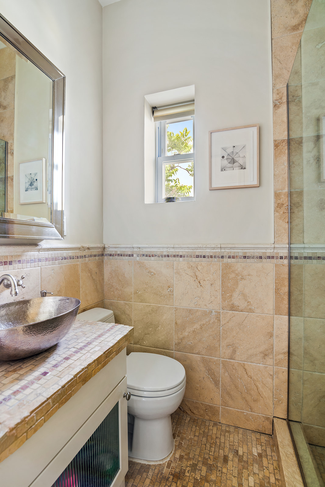 77 Perry Street, Unit 6CD Manhattan, NY 10014 - Photo 13 of 16 a bathroom with a granite countertop toilet sink and mirror