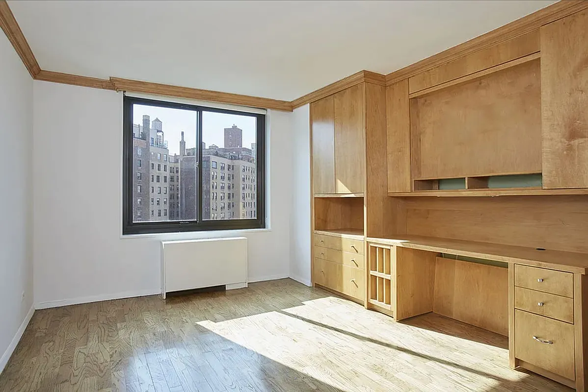 40 East 94th Street, Unit 13G Manhattan, NY 10128 - Photo 6 of 13 a view of an empty room with a window and wooden floor