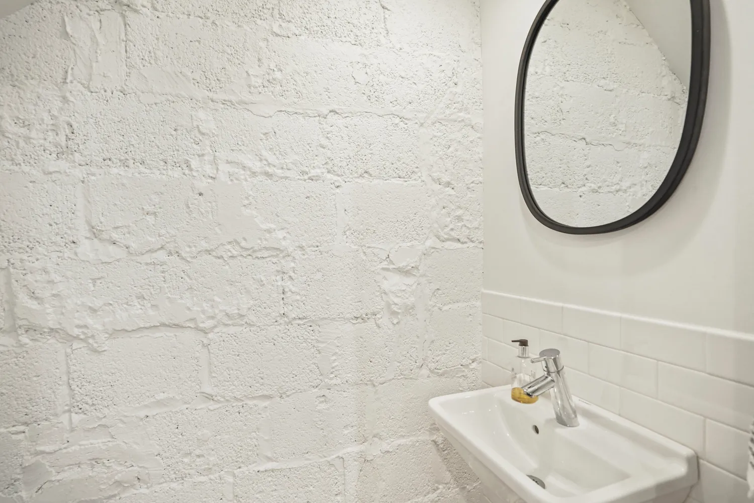 a bathroom with a sink a mirror and a shower