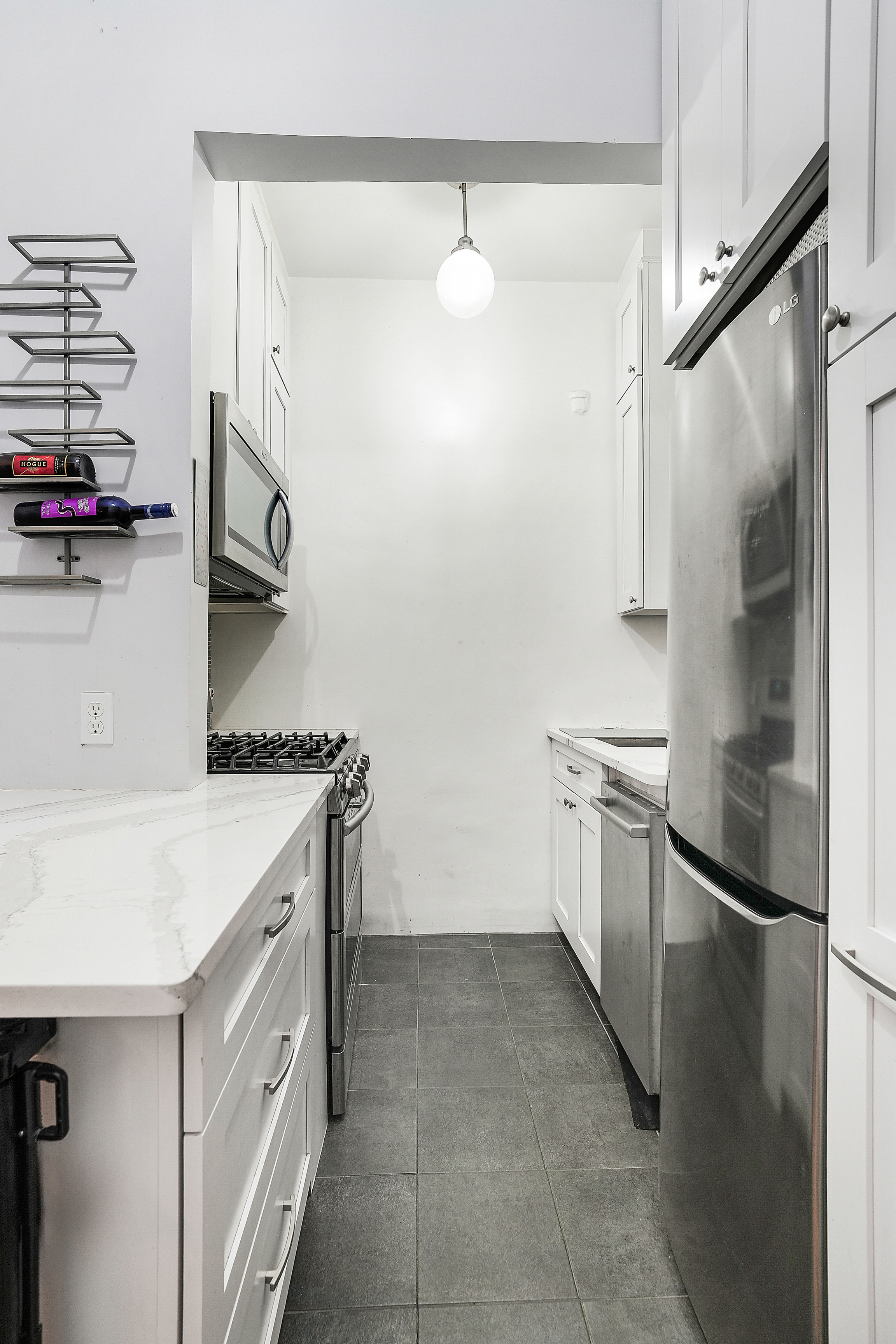 205 West 54th Street, Unit 3A Manhattan, NY 10019 - Photo 8 of 14 a kitchen with a sink and a refrigerator