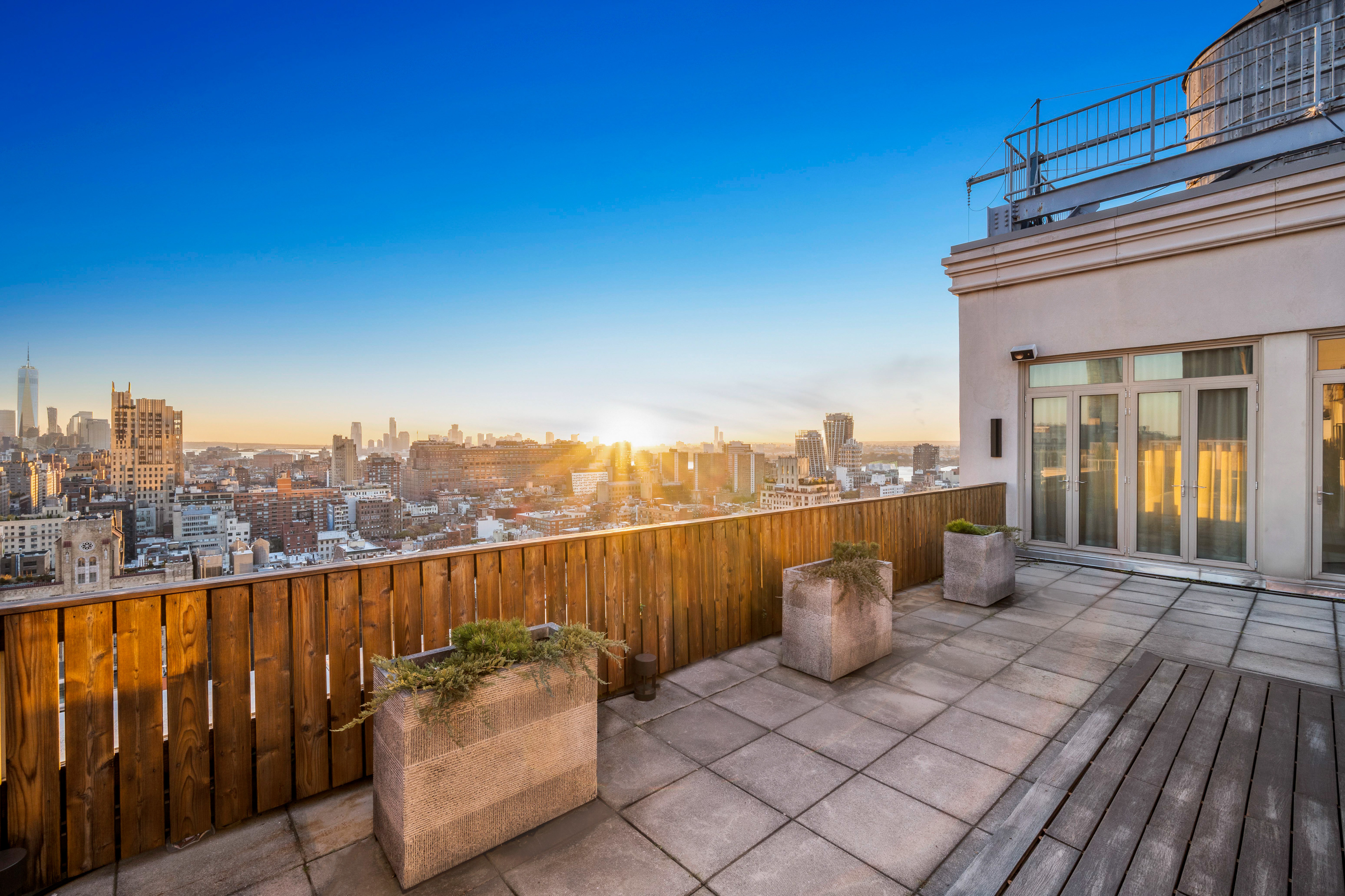 252 7th Avenue, Unit PHD Manhattan, NY 10001 - Photo 8 of 26 a view of a roof deck with couches and wooden floor