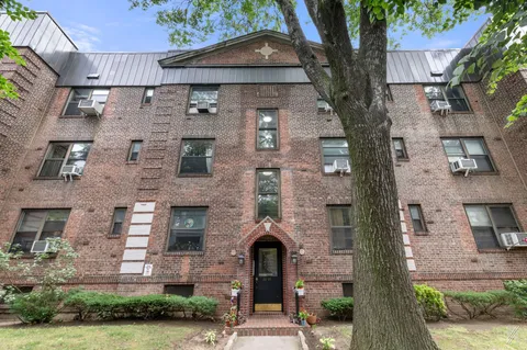 a front view of a building with garden