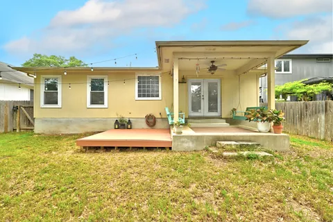 a view of a house with swimming pool and a yard
