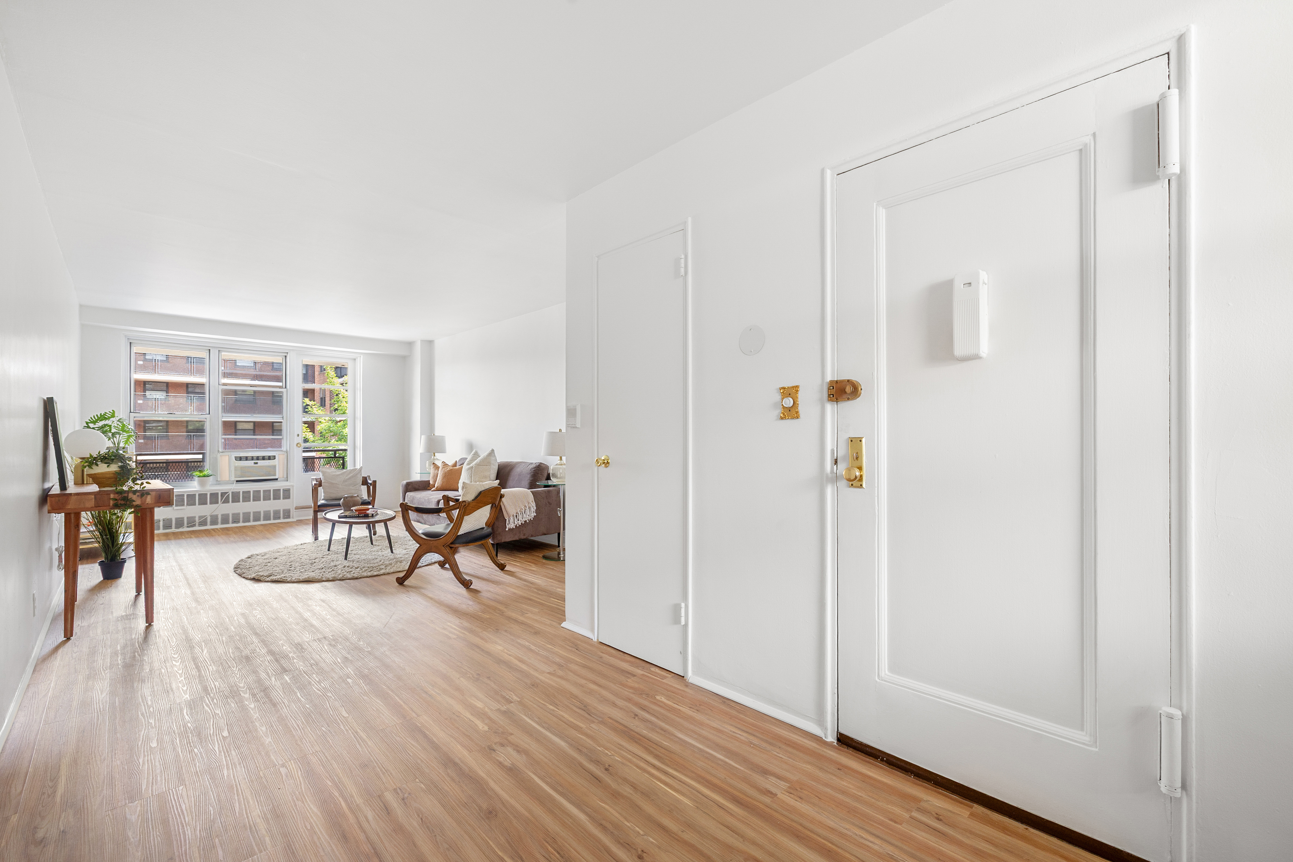 35-31 85th Street, Unit 6C Queens, NY 11372 - Photo 4 of 11 a living room with furniture and a wooden floor