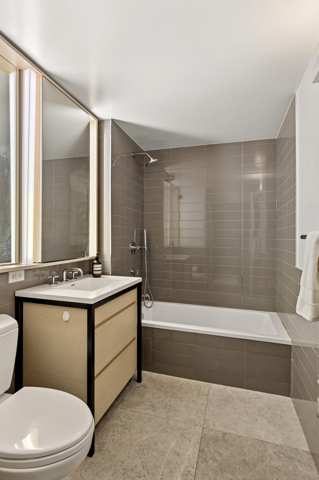 385 1st Avenue, Unit 6B Manhattan, NY 10010 - Photo 9 of 15 a bathroom with a sink a toilet and shower