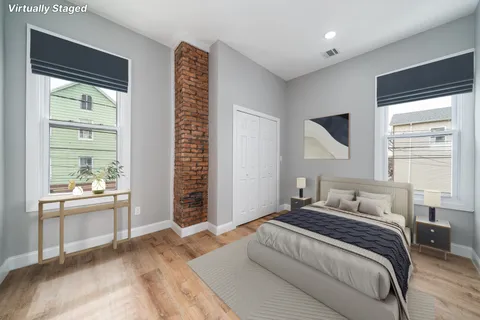 a bedroom with a large bed and a window