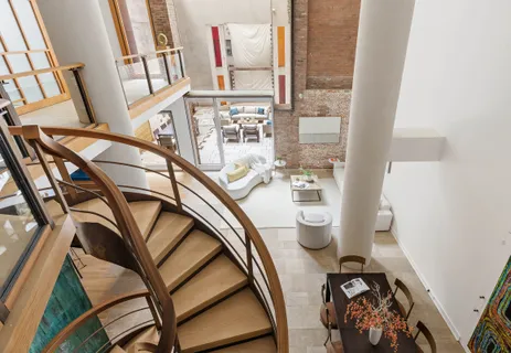 a view of a livingroom with wooden floor and a floor to ceiling window