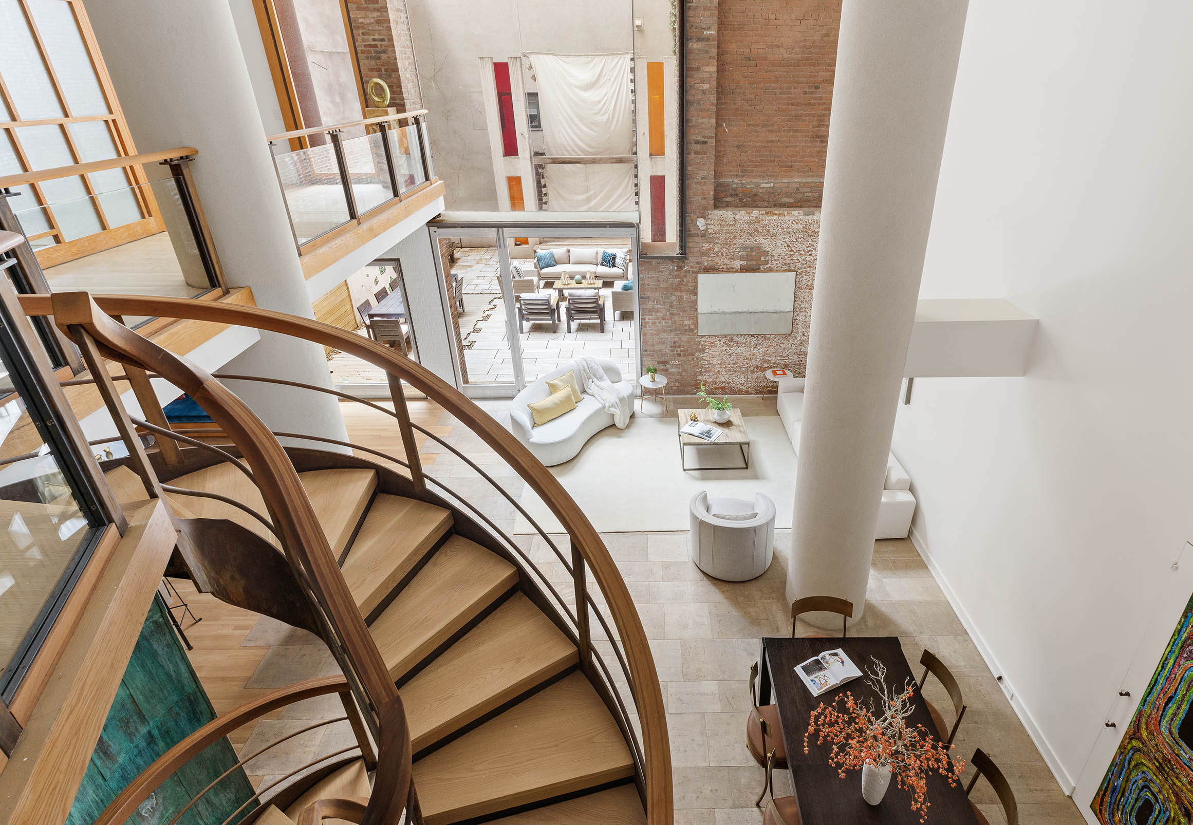 a view of a livingroom with wooden floor and a floor to ceiling window
