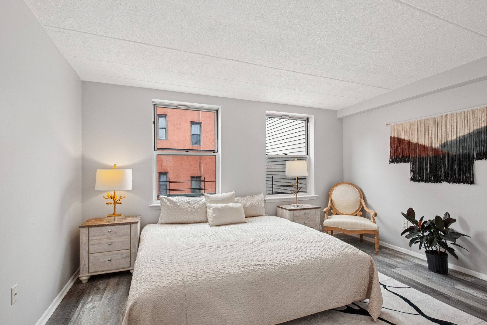2551 Frederick Douglass Boulevard, Unit 2551D Manhattan, NY 10030 - Photo 5 of 11 a bedroom with a bed a couch and dresser