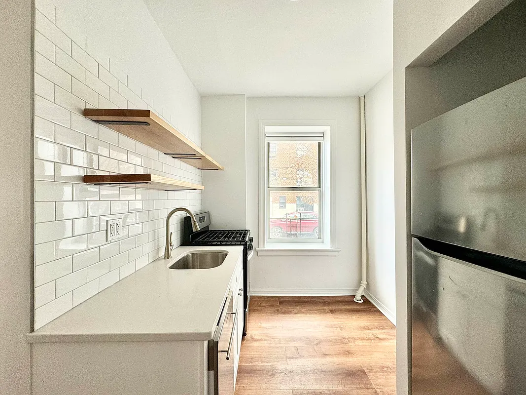2022 Beverley Road, Unit 3 Brooklyn, NY 11226 - Photo 2 of 11 a kitchen with a sink a stove and a refrigerator
