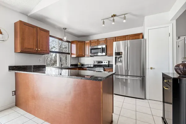 a bedroom with a bed and dresser with wooden floor