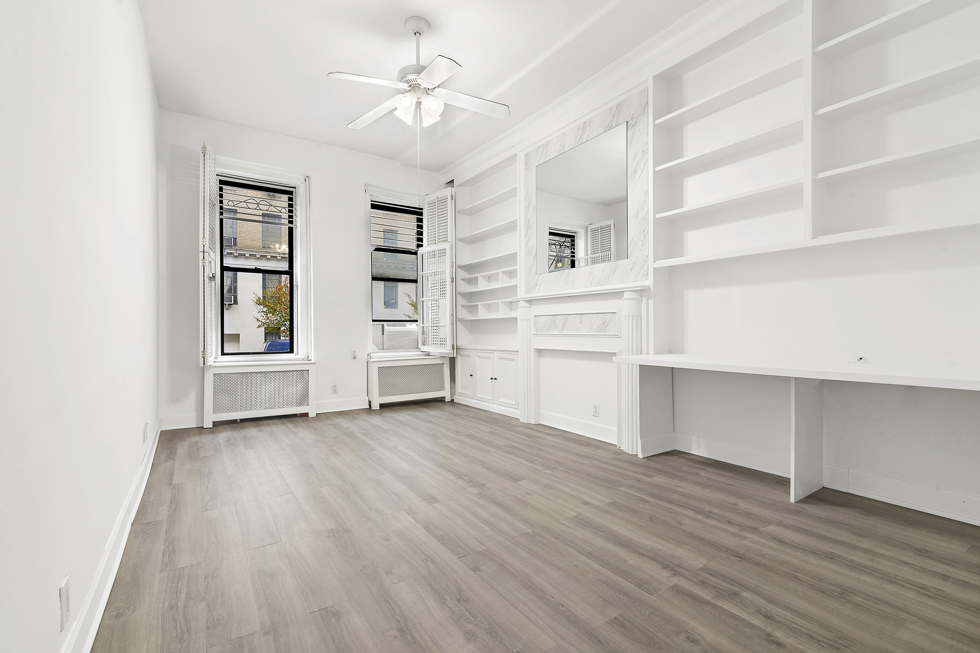 wooden floor in an empty room with a window