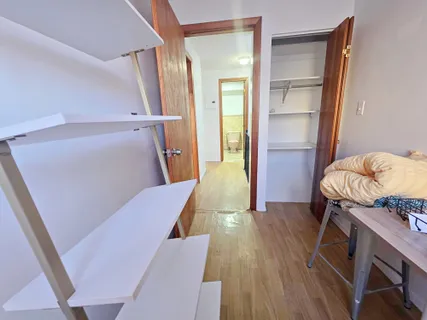 a view of hallway with wooden floor and stairs