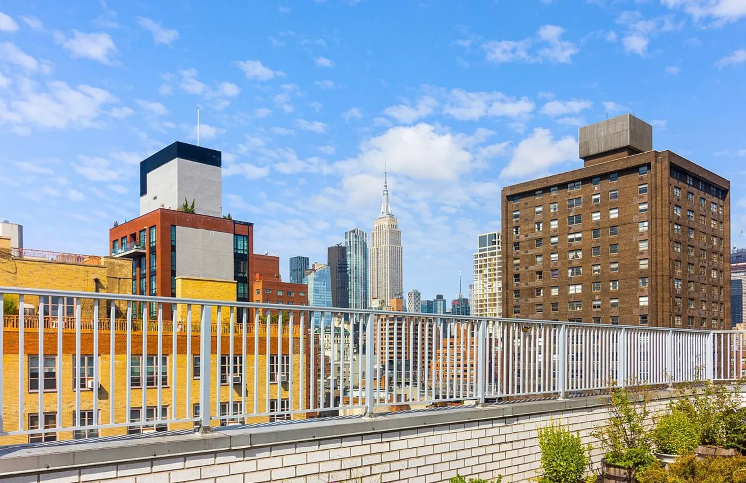 a view of a patio with couches table and chairs and potted plants