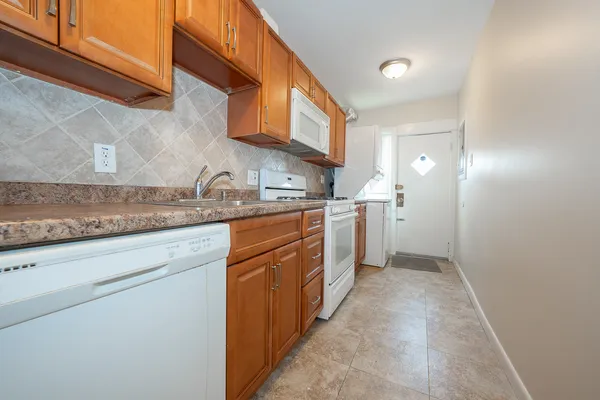 a kitchen with stainless steel appliances granite countertop a sink and cabinets