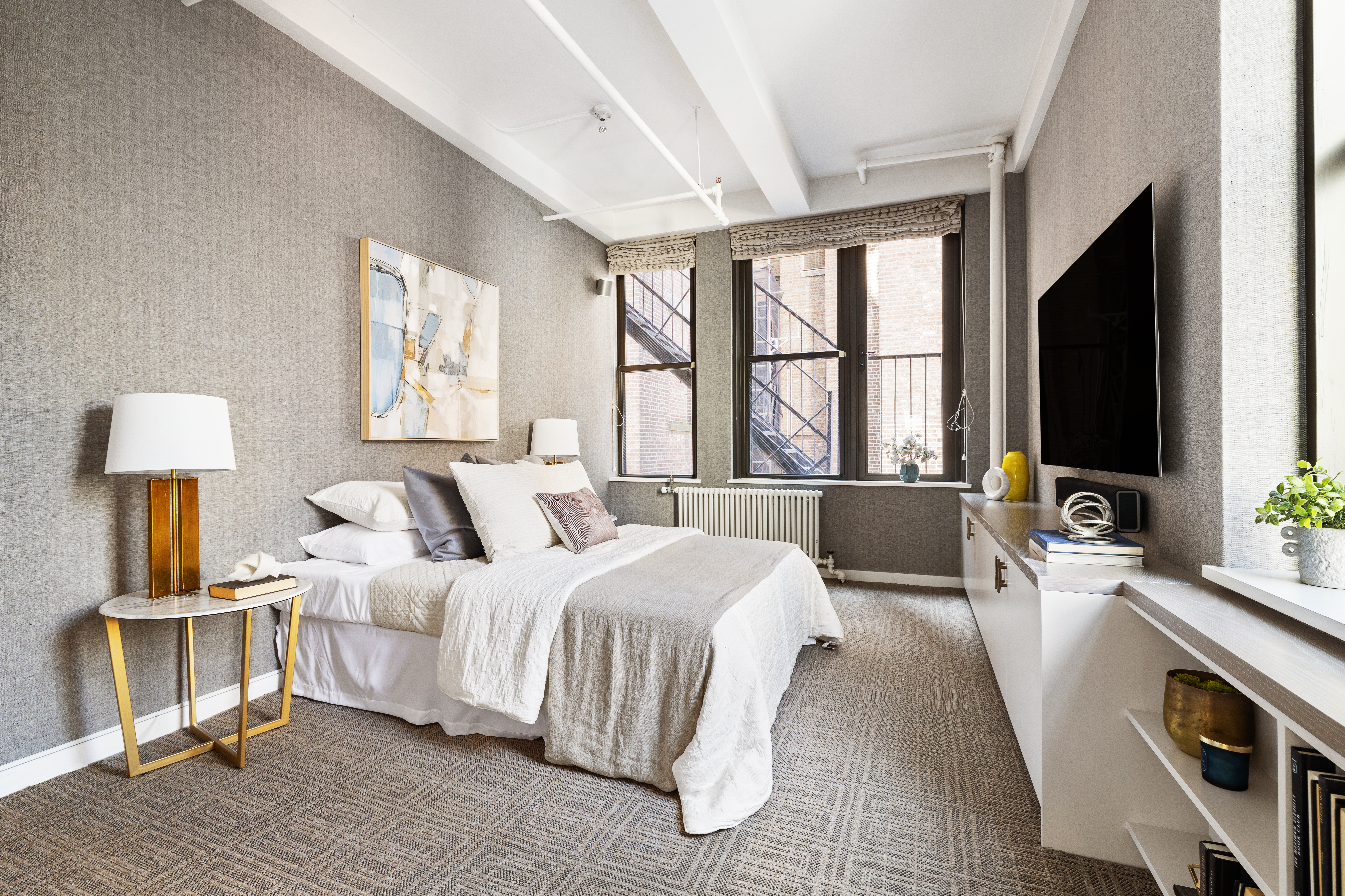 24 West 30th Street, Unit 6 Manhattan, NY 10001 - Photo 8 of 14 a bedroom with a bed and a flat screen tv