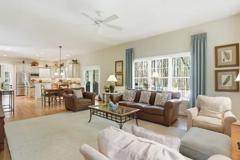 a living room with furniture couches and a large window