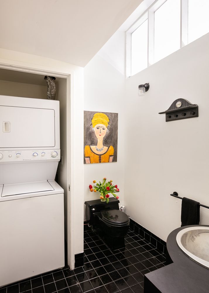 366 Broadway, Unit 3C Manhattan, NY 10013 - Photo 9 of 10 a bathroom with a toilet and a shower curtain