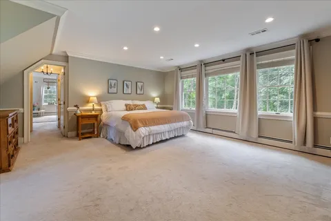 a bedroom with a bed and a couch