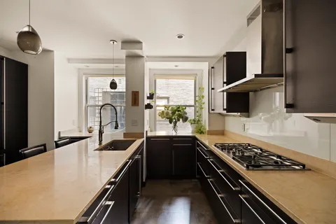 a kitchen with stainless steel appliances a sink dishwasher stove refrigerator and microwave