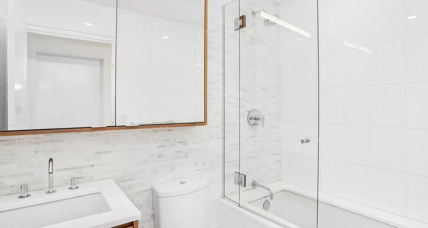 301 West 53rd Street, Unit 14C Manhattan, NY 10019 - Photo 5 of 12 a bathroom with a sink and a shower