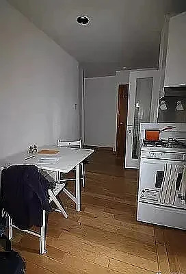 402 East 69th Street, Unit 23 Manhattan, NY 10065 - Photo 4 of 6 a view of a dining room with furniture