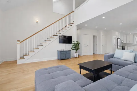 a living room with furniture fireplace and dining table