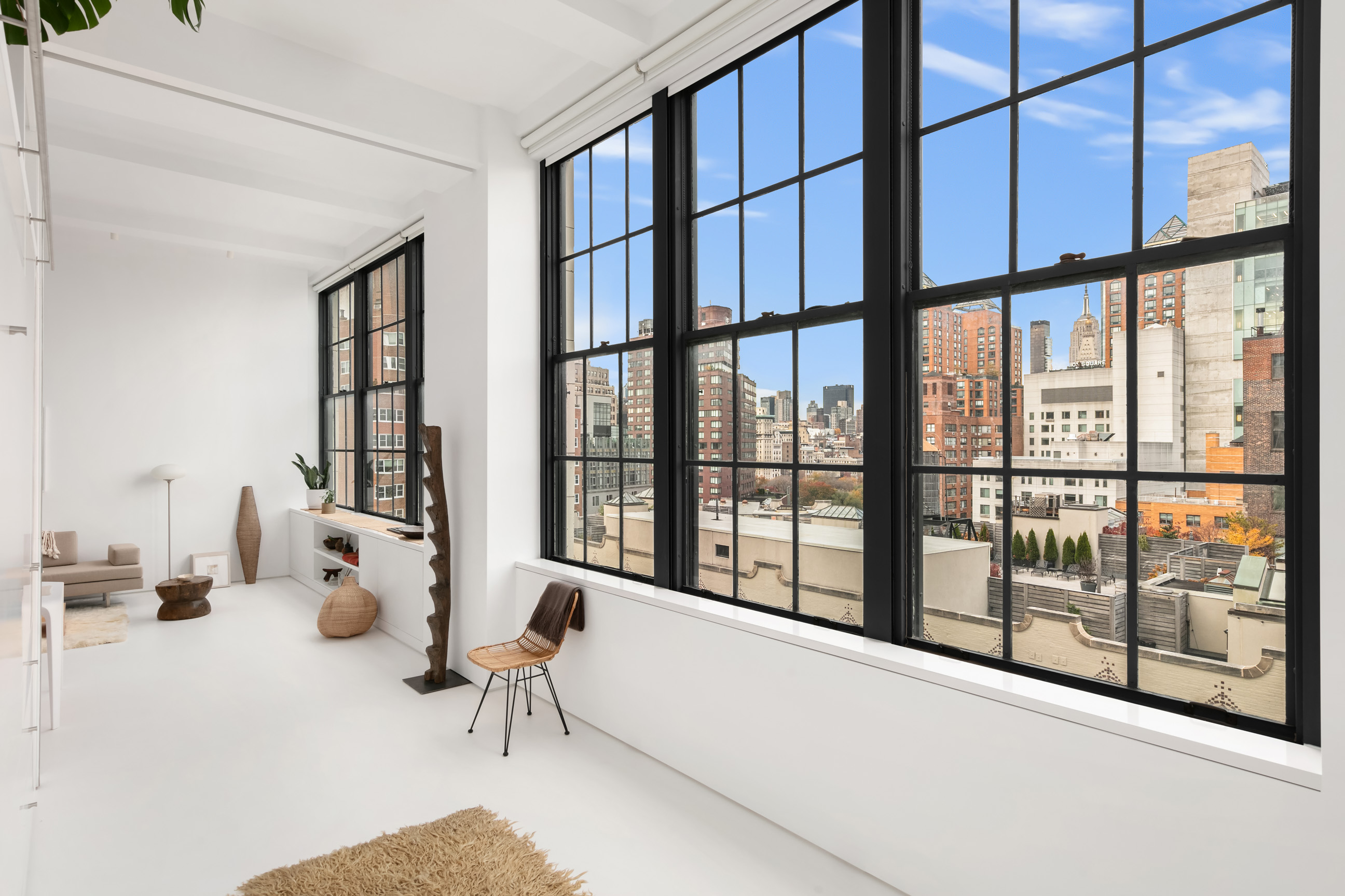 111 4th Avenue, Unit 9M Manhattan, NY 10003 - Photo 7 of 14 a living room with furniture and floor to ceiling window