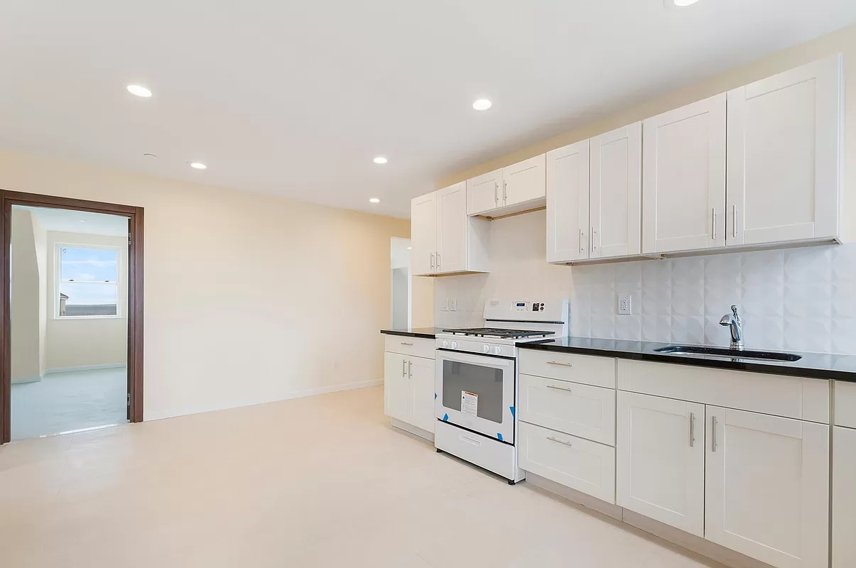 4015 Atlantic Avenue Brooklyn, NY 11224 - Photo 9 of 14 a kitchen with stainless steel appliances granite countertop a sink and a stove