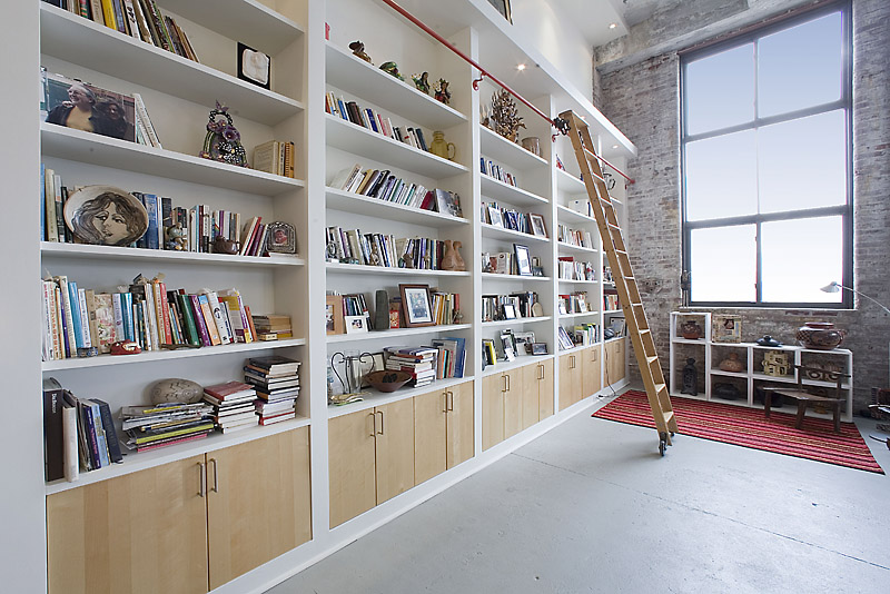 330 Wythe Avenue, Unit 4J Brooklyn, NY 11249 - Photo 2 of 6 a room with lots of books and a large window
