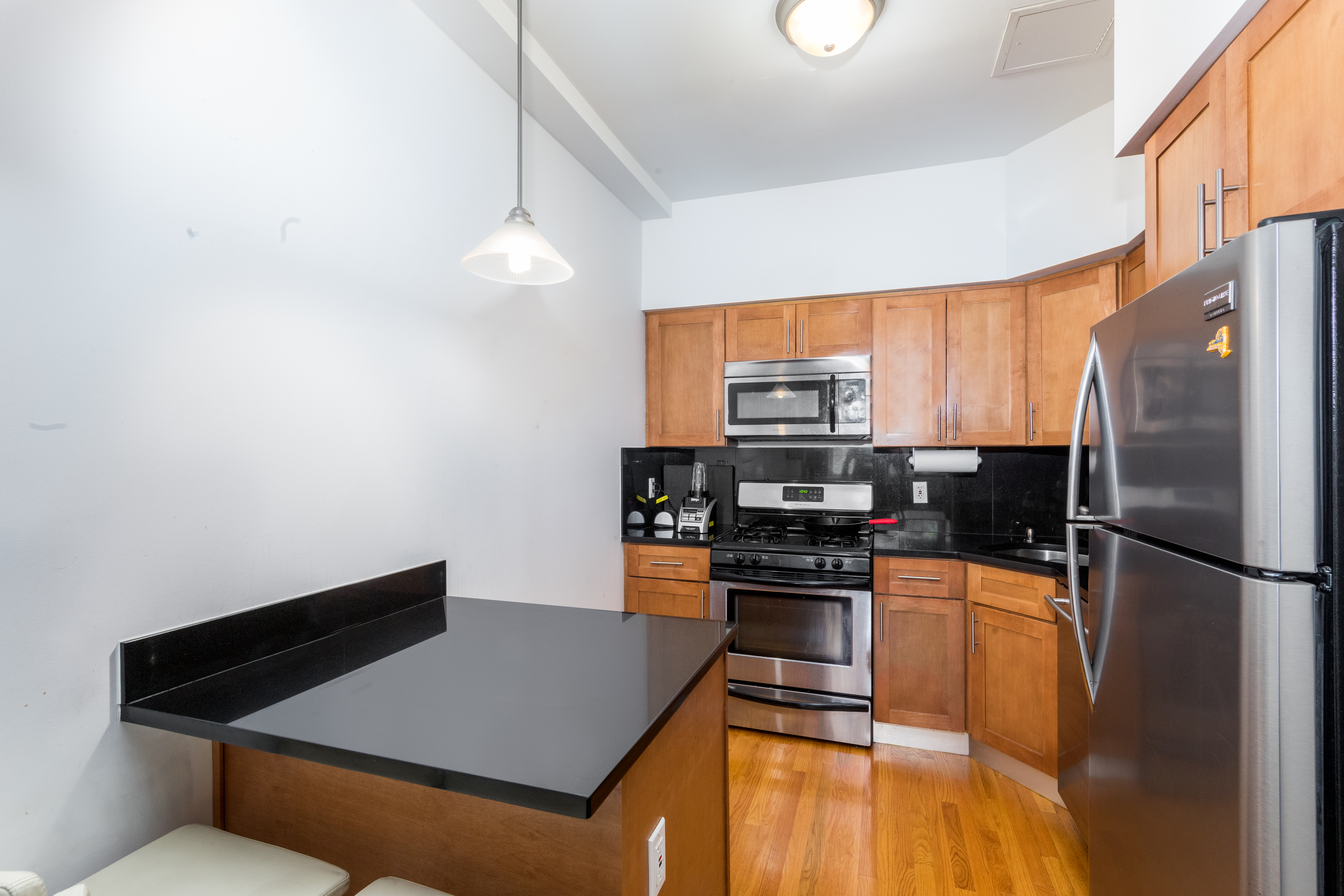 713 Metropolitan Avenue, Unit 2R Brooklyn, NY 11211 - Photo 2 of 5 a kitchen with stainless steel appliances granite countertop a refrigerator a stove and a sink